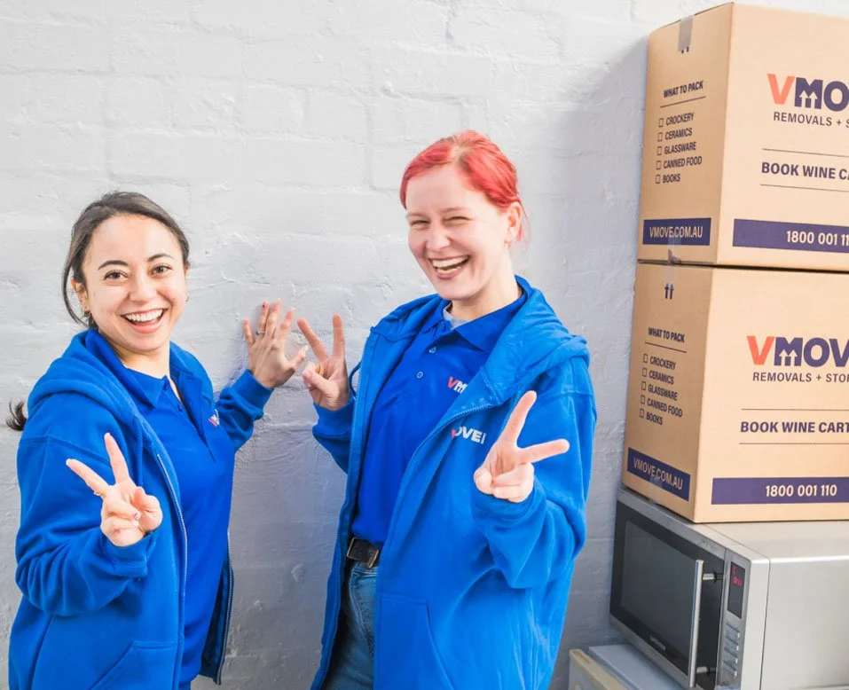 2 removalist sydney smiling infront of boxes