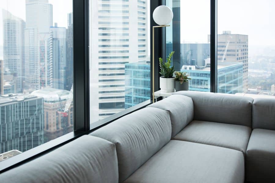 Modern apartment interior with city view overlooking Melbourne skyscrapers.