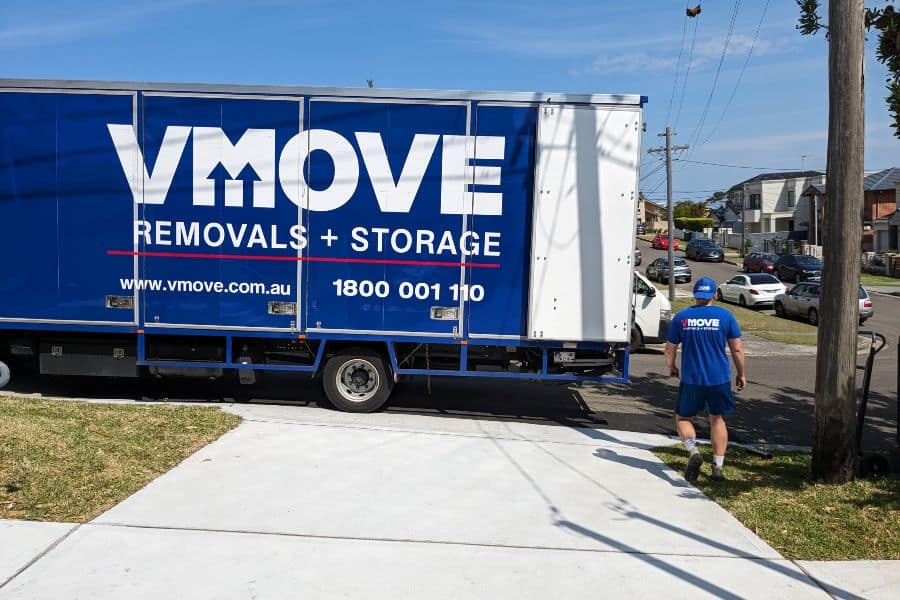 Vmove removals and storage truck with a mover preparing for a residential relocation in Sydney.
